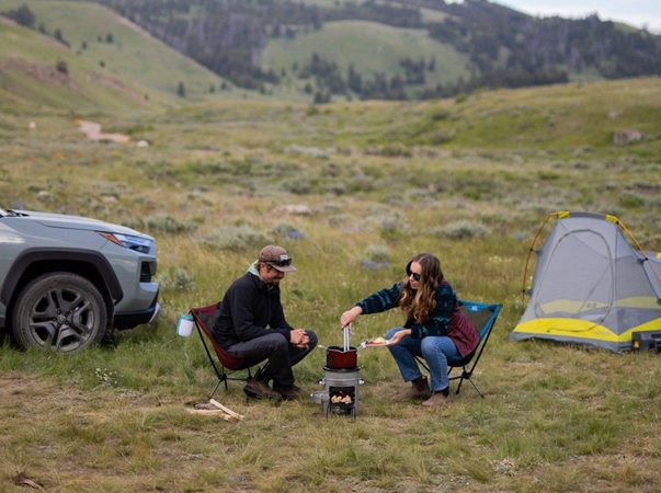 two overlanders use the biolite ecozoom stoves in the wild with their tent pitched